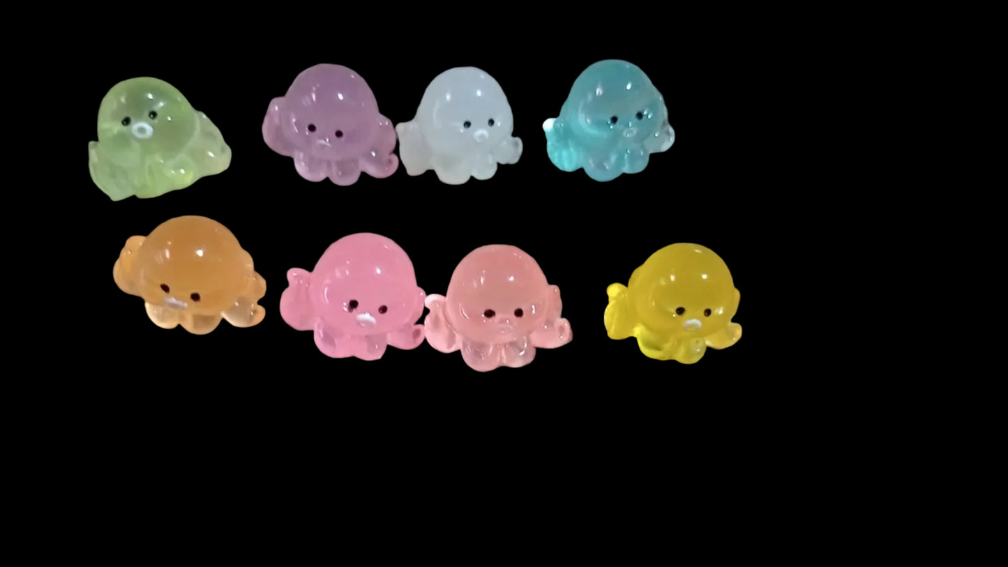 Colorful octopus-shaped figures on a black background
