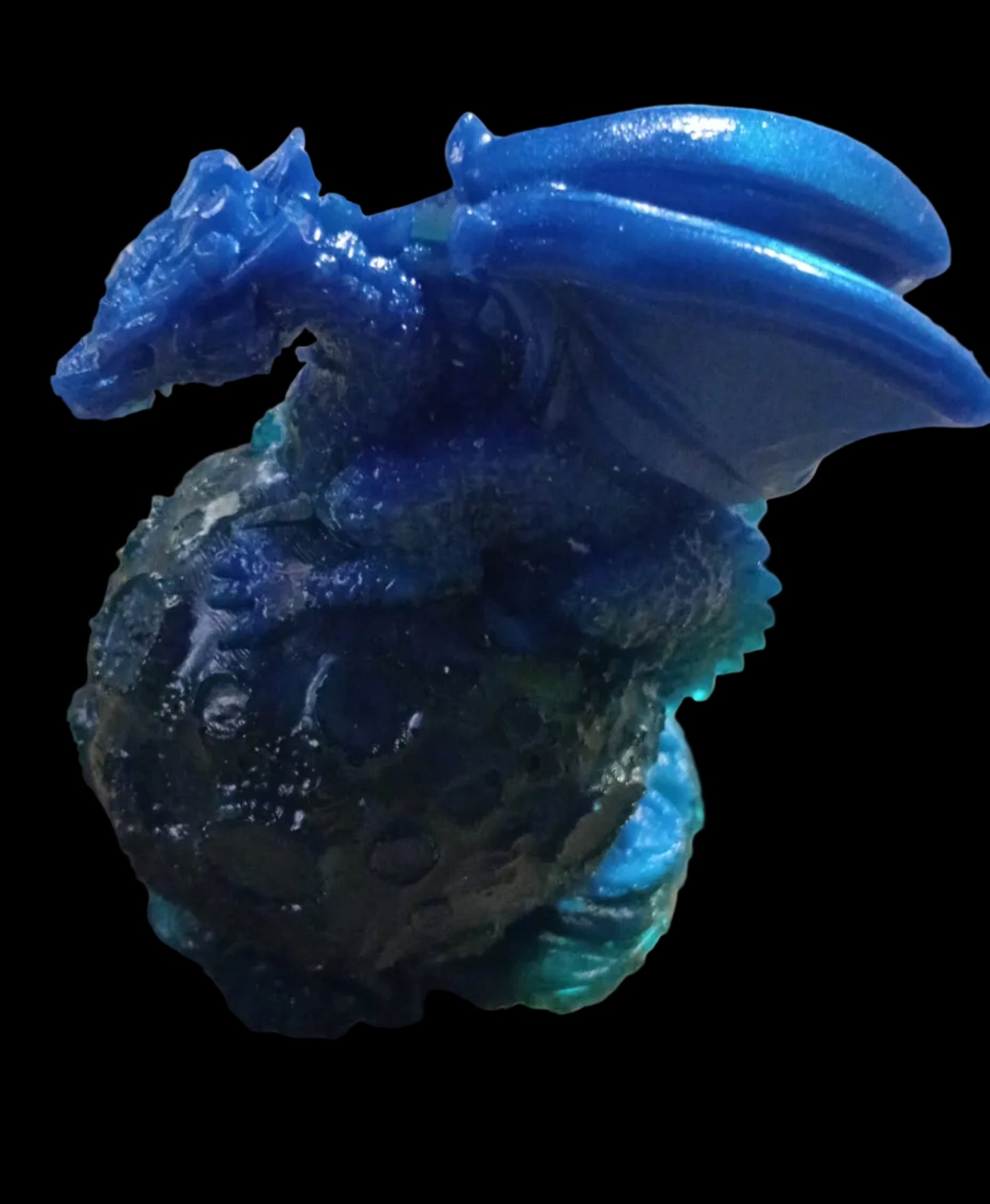 Resin dragon sitting on moon