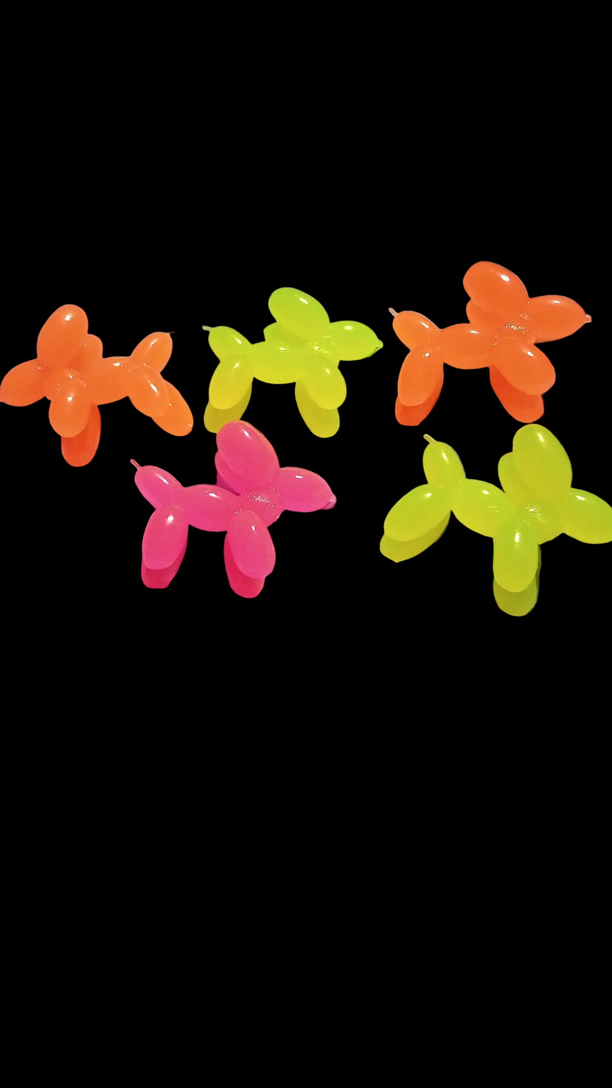 Colorful balloon animals on a bed