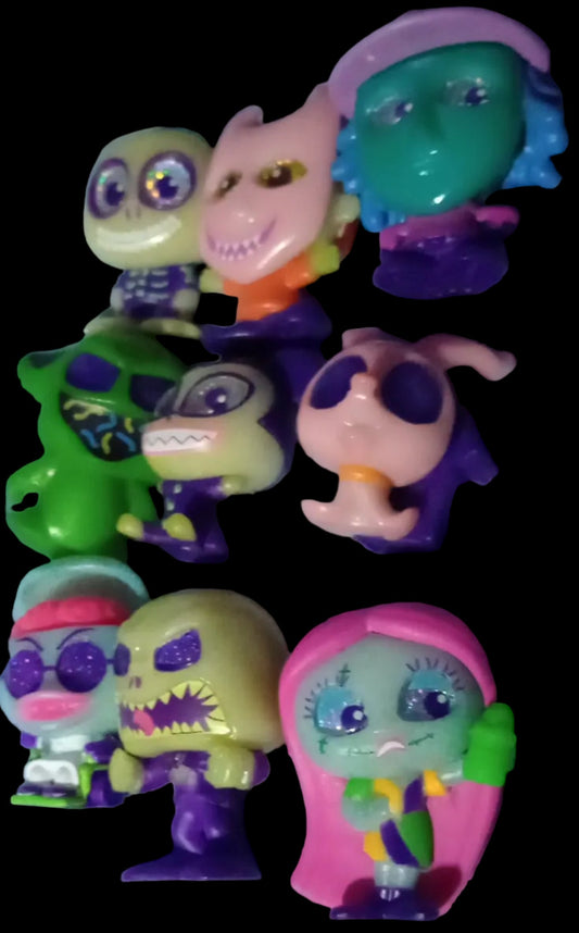 Collection of colorful toy figures on a black background