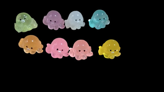 Colorful octopus-shaped figures on a black background