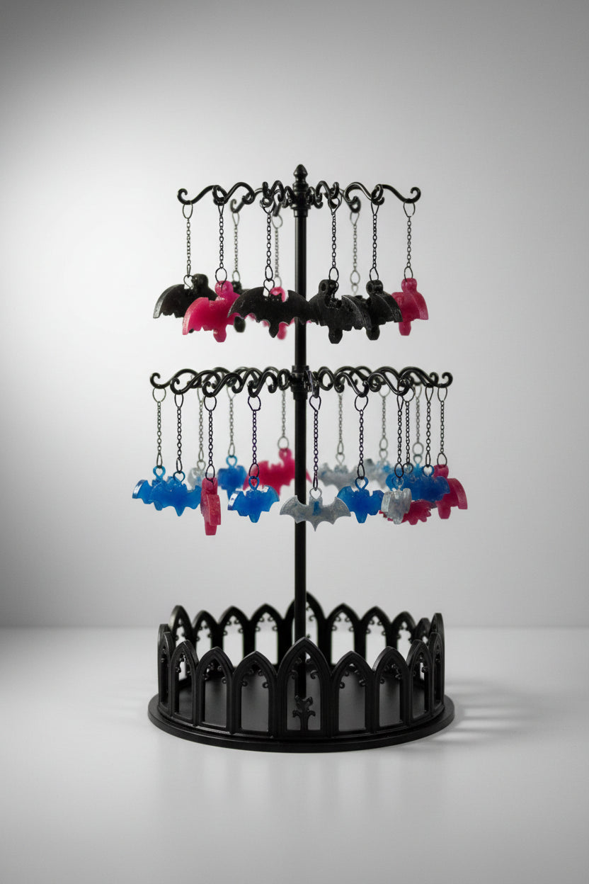 Colorful bat-shaped objects on a white fabric background